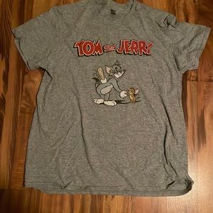 A Tom and Jerry tee shirt, women’s L, has a picture of Tom and Jerry on it.